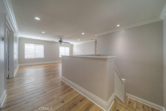 unfurnished room with crown molding, recessed lighting, baseboards, and light wood-type flooring