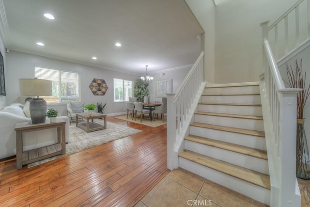 interior space with recessed lighting, a notable chandelier, ornamental molding, and wood finished floors