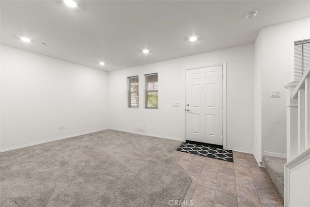entrance foyer with stairway, baseboards, and recessed lighting