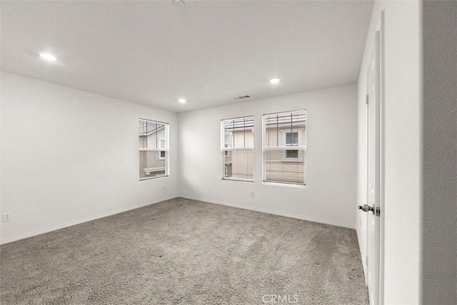 carpeted empty room with recessed lighting, plenty of natural light, visible vents, and baseboards