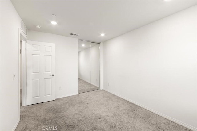 interior space featuring recessed lighting, carpet floors, visible vents, and baseboards