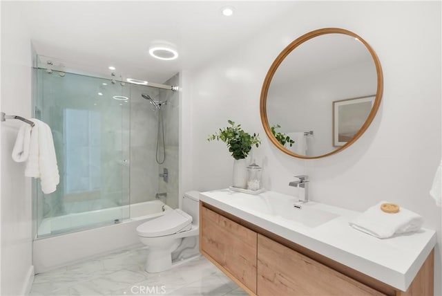 bathroom featuring recessed lighting, vanity, toilet, marble finish floor, and combined bath / shower with glass door