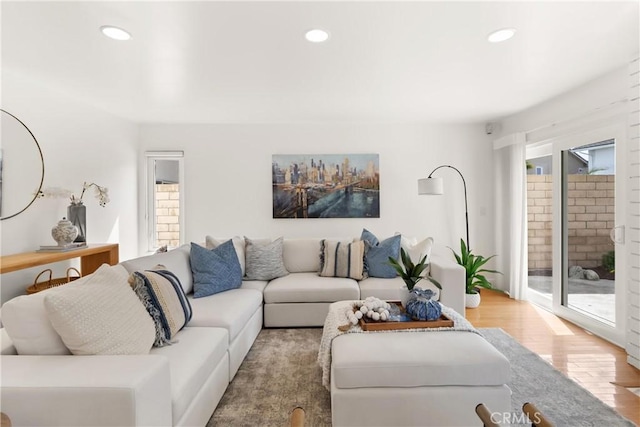 living room with recessed lighting, wood finished floors, and a healthy amount of sunlight