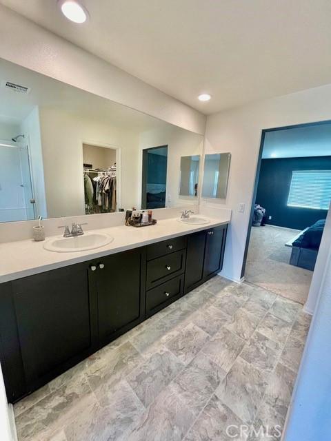 2819 La Calle Sabio Ave, Rosamond, CA 93560 - full bath with double vanity, a spacious closet, and recessed lighting