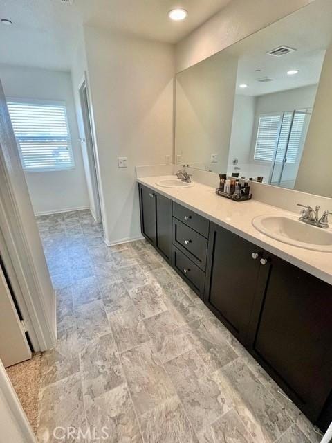 2819 La Calle Sabio Ave, Rosamond, CA 93560 - full bathroom featuring plenty of natural light, double vanity, and baseboards