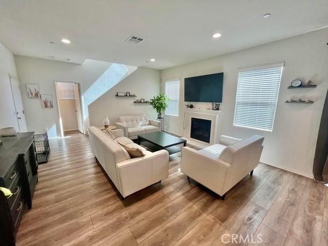 2819 La Calle Sabio Ave, Rosamond, CA 93560 - living room featuring light wood-style flooring, a fireplace, and recessed lighting