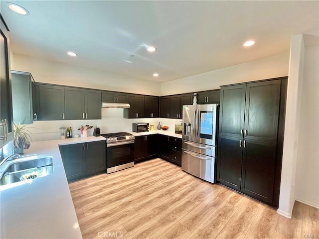 2819 La Calle Sabio Ave, Rosamond, CA 93560 - kitchen featuring stainless steel appliances, under cabinet range hood, a sink, light countertops, and recessed lighting