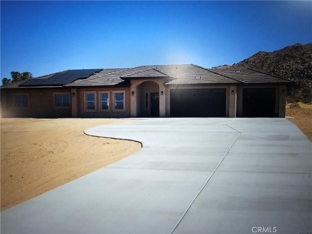 view of front of house featuring an attached garage and concrete driveway