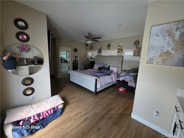 24236 Cahuilla Rd, Apple Valley, CA 92307 - bedroom with wood finished floors, baseboards, and ceiling fan