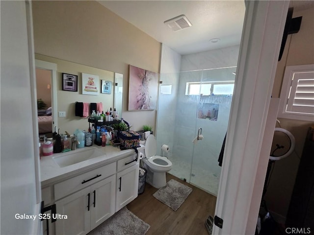 24236 Cahuilla Rd, Apple Valley, CA 92307 - ensuite bathroom featuring a stall shower, vanity, wood finished floors, and toilet