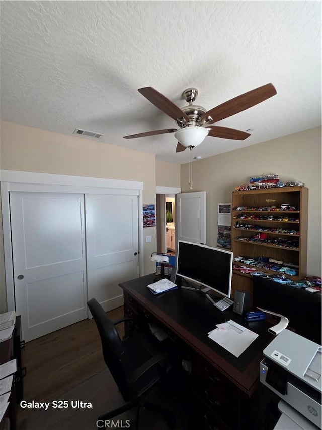 24236 Cahuilla Rd, Apple Valley, CA 92307 - office with ceiling fan, dark wood-type flooring, and a textured ceiling