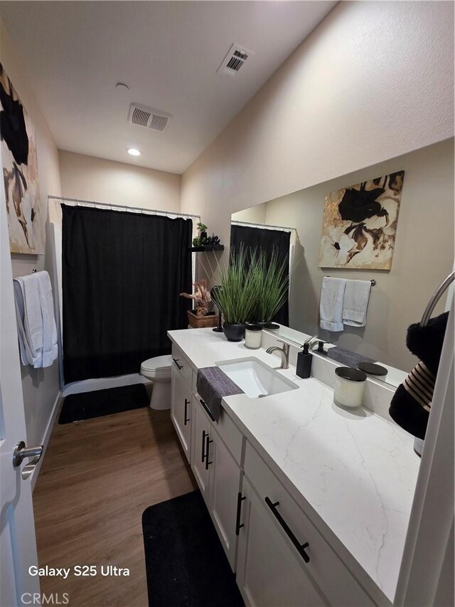 24236 Cahuilla Rd, Apple Valley, CA 92307 - bathroom with vanity, toilet, wood finished floors, and recessed lighting