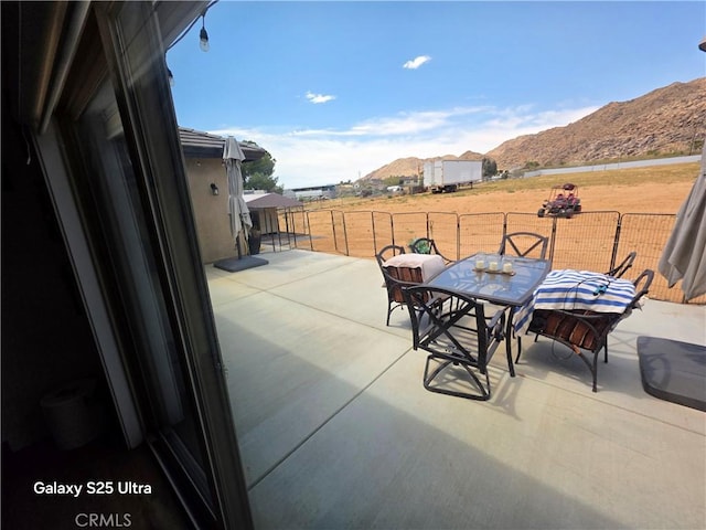 24236 Cahuilla Rd, Apple Valley, CA 92307 - view of patio with a mountain view and outdoor dining area