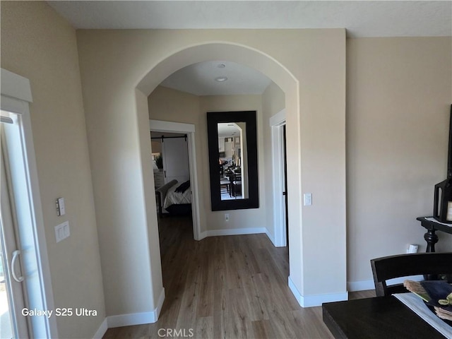 24236 Cahuilla Rd, Apple Valley, CA 92307 - hallway with light wood-style flooring, baseboards, and arched walkways