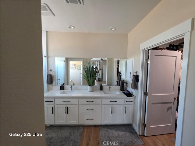 24236 Cahuilla Rd, Apple Valley, CA 92307 - bathroom featuring wood finished floors, double vanity, and ceiling fan