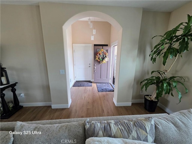 24236 Cahuilla Rd, Apple Valley, CA 92307 - entrance foyer featuring arched walkways, wood finished floors, and baseboards