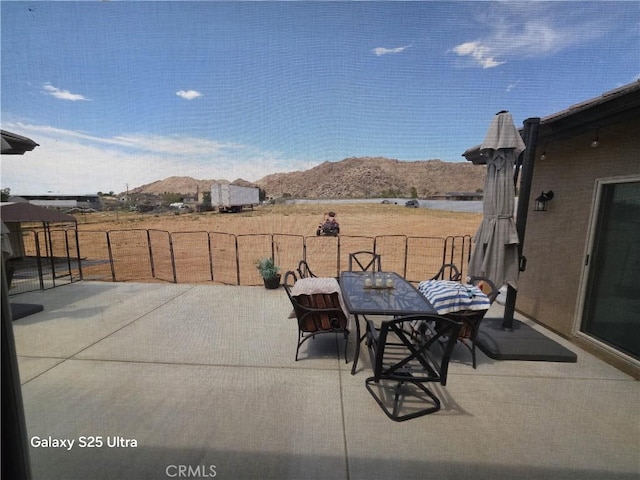 24236 Cahuilla Rd, Apple Valley, CA 92307 - view of patio featuring a mountain view and outdoor dining space