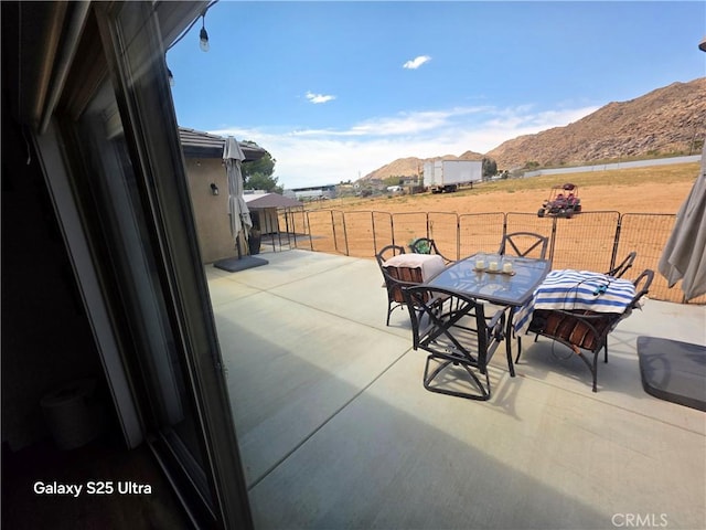 24236 Cahuilla Rd, Apple Valley, CA 92307 - view of patio / terrace with a mountain view and outdoor dining area