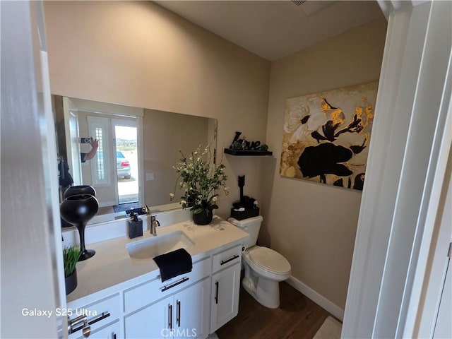24236 Cahuilla Rd, Apple Valley, CA 92307 - bathroom featuring vanity, toilet, and wood finished floors