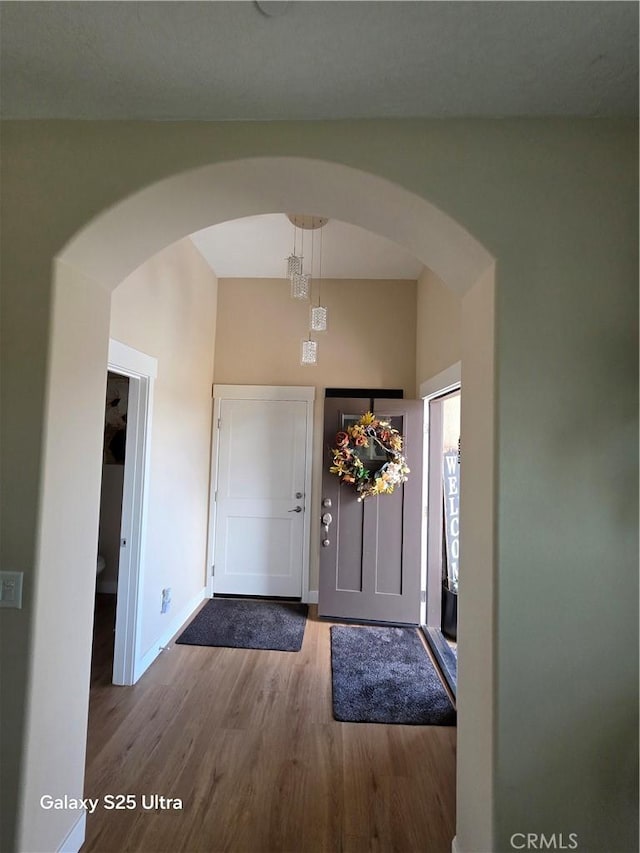 24236 Cahuilla Rd, Apple Valley, CA 92307 - foyer with arched walkways, wood finished floors, and baseboards