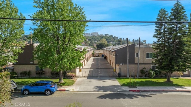 630 E Acacia Ave Unit 6, Glendale, CA 91205 - view of front of property featuring a gate, a front lawn, and stucco siding
