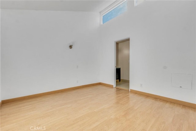 630 E Acacia Ave Unit 6, Glendale, CA 91205 - empty room featuring light wood-type flooring, baseboards, and a high ceiling