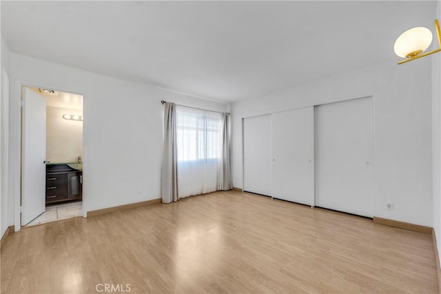 630 E Acacia Ave Unit 6, Glendale, CA 91205 - unfurnished bedroom featuring baseboards, wood finished floors, and ensuite bath