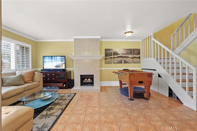 11 Northwind Ct Unit 41, Newport Beach, CA 92663 - living area featuring ornamental molding, tile patterned flooring, stairs, and a fireplace