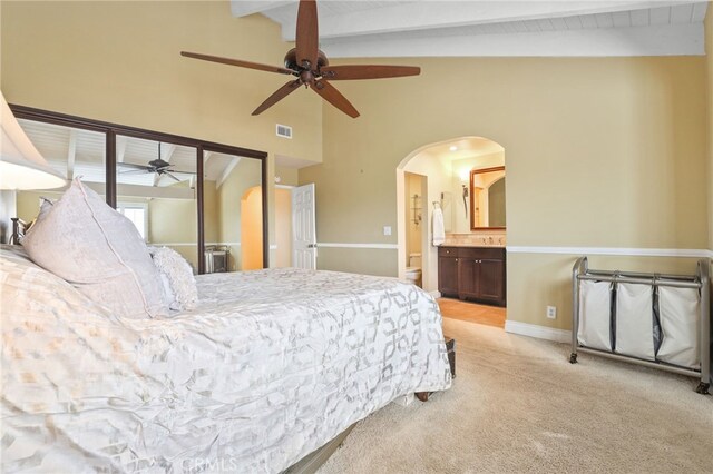 11 Northwind Ct Unit 41, Newport Beach, CA 92663 - bedroom featuring light carpet, arched walkways, ensuite bath, and a ceiling fan