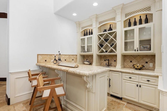 5015 Rancho Quinta Bnd, San Diego, CA 92130 - indoor wet bar featuring stone tile floors, tasteful backsplash, recessed lighting, and wainscoting