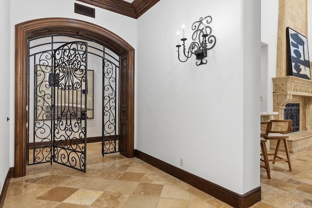 5015 Rancho Quinta Bnd, San Diego, CA 92130 - entrance foyer with arched walkways, stone tile flooring, and crown molding