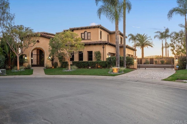 5015 Rancho Quinta Bnd, San Diego, CA 92130 - mediterranean / spanish house featuring a gate, stucco siding, and a tile roof