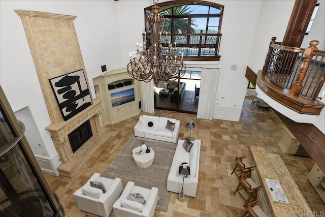 5015 Rancho Quinta Bnd, San Diego, CA 92130 - living area featuring a premium fireplace, a chandelier, and a towering ceiling