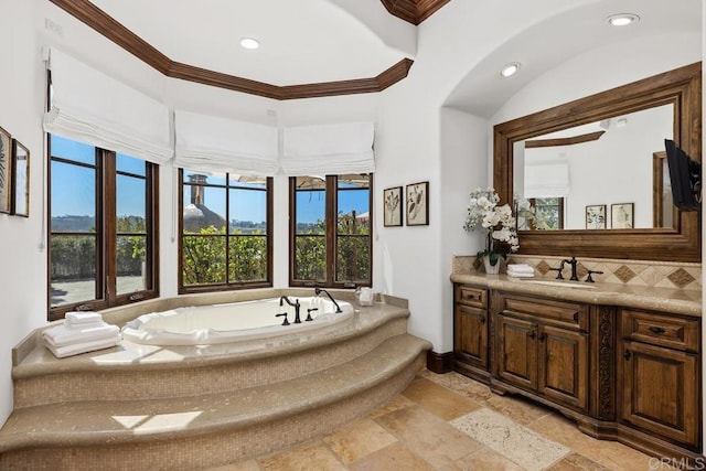 5015 Rancho Quinta Bnd, San Diego, CA 92130 - bathroom with vanity, stone tile floors, a garden tub, backsplash, and crown molding