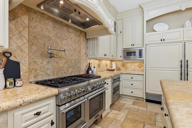 5015 Rancho Quinta Bnd, San Diego, CA 92130 - kitchen featuring appliances with stainless steel finishes, custom exhaust hood, white cabinetry, decorative backsplash, and stone tile floors