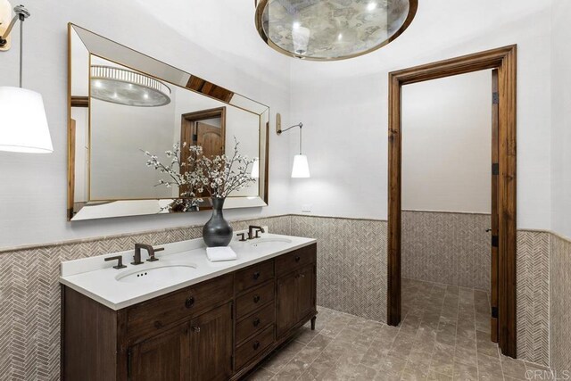 5015 Rancho Quinta Bnd, San Diego, CA 92130 - full bath featuring tile walls, wainscoting, and double vanity