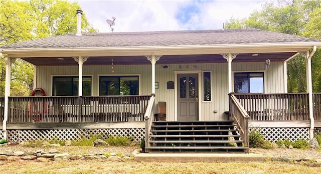 view of front of house with roof with shingles and a porch