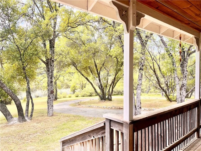 wooden terrace featuring a lawn