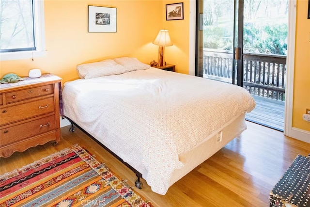 bedroom featuring access to outside and light wood-style floors