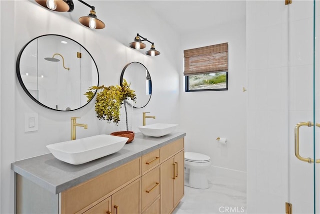 full bathroom with a shower stall, marble finish floor, toilet, and a sink