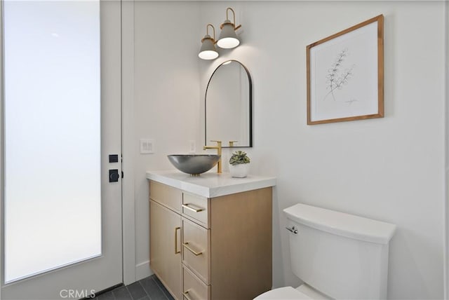 bathroom featuring toilet and vanity