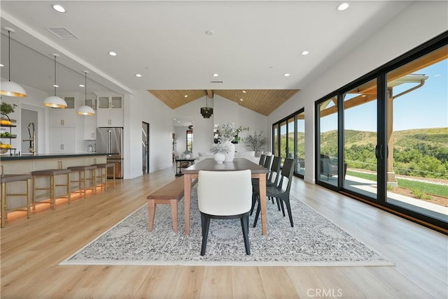 dining room featuring recessed lighting, lofted ceiling, visible vents, and light wood-style flooring