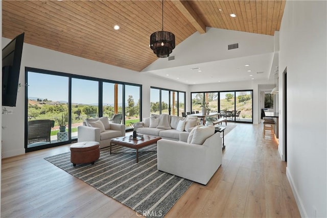 living area featuring light wood-style floors, baseboards, beam ceiling, and high vaulted ceiling