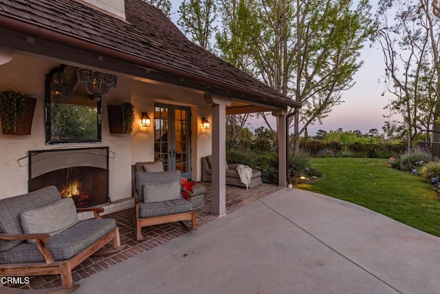 233 Hillside Rd, South Pasadena, CA 91030 - patio terrace at dusk with french doors, a yard, and an outdoor living space with a fireplace