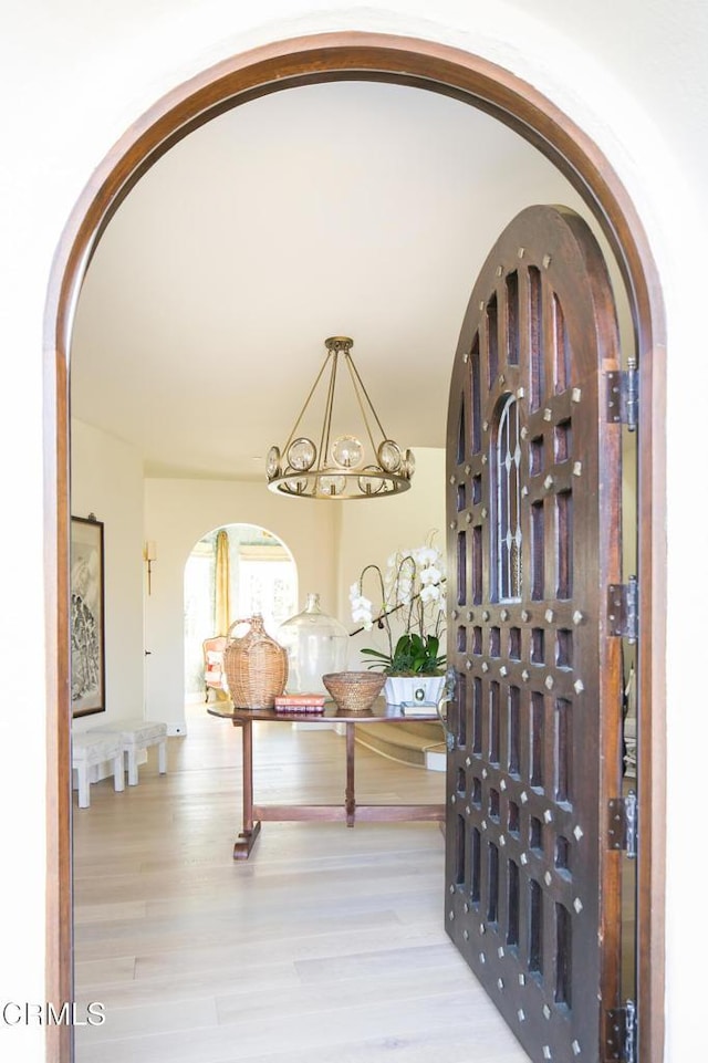 233 Hillside Rd, South Pasadena, CA 91030 - entryway featuring arched walkways, wood finished floors, and a chandelier