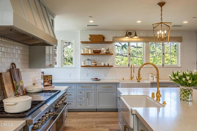 233 Hillside Rd, South Pasadena, CA 91030 - kitchen with extractor fan, range with two ovens, light countertops, and light wood-type flooring