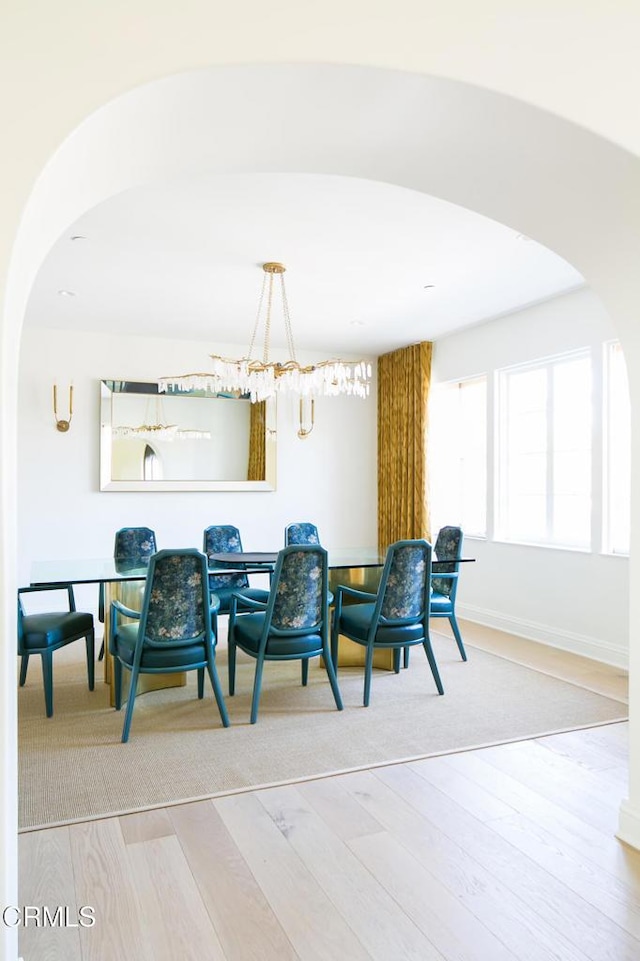 233 Hillside Rd, South Pasadena, CA 91030 - dining room with arched walkways, wood finished floors, baseboards, and a chandelier