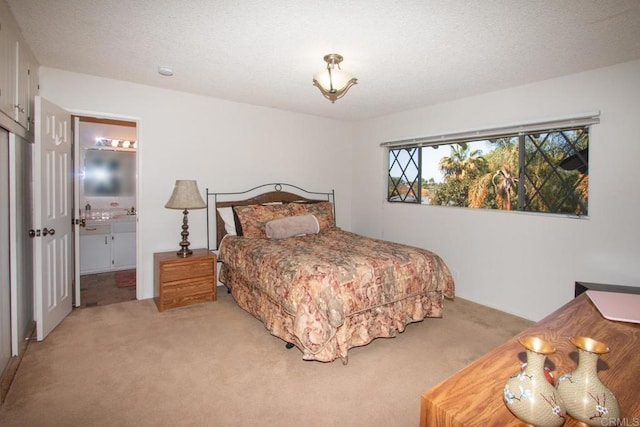 bedroom with light carpet and ensuite bathroom