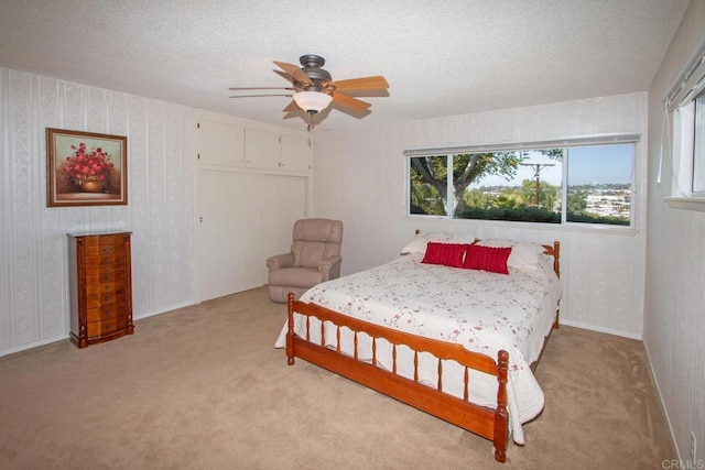 bedroom with light carpet, wallpapered walls, and multiple windows