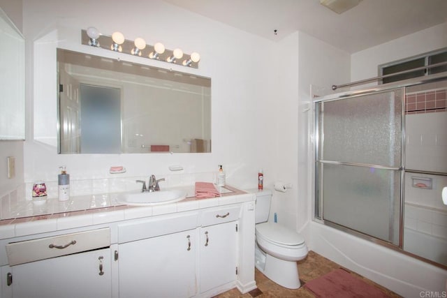 full bath with toilet, vanity, and enclosed tub / shower combo